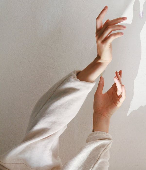 A person with open arms on an abstract background.