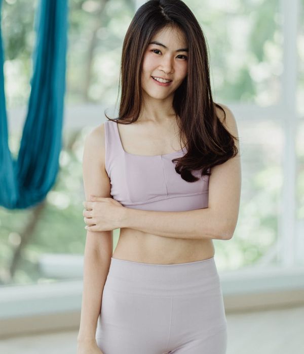 Portrait of a smiling woman in yoga clothes.