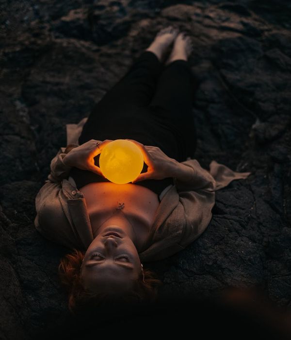Woman meditating peacefully in a glowing energy field.